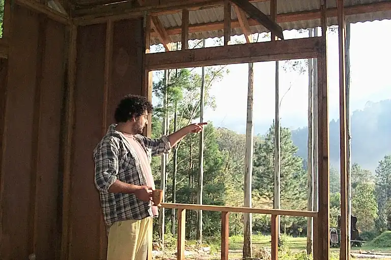 Joff pointing out of the house towards mount Warning a view to die for.